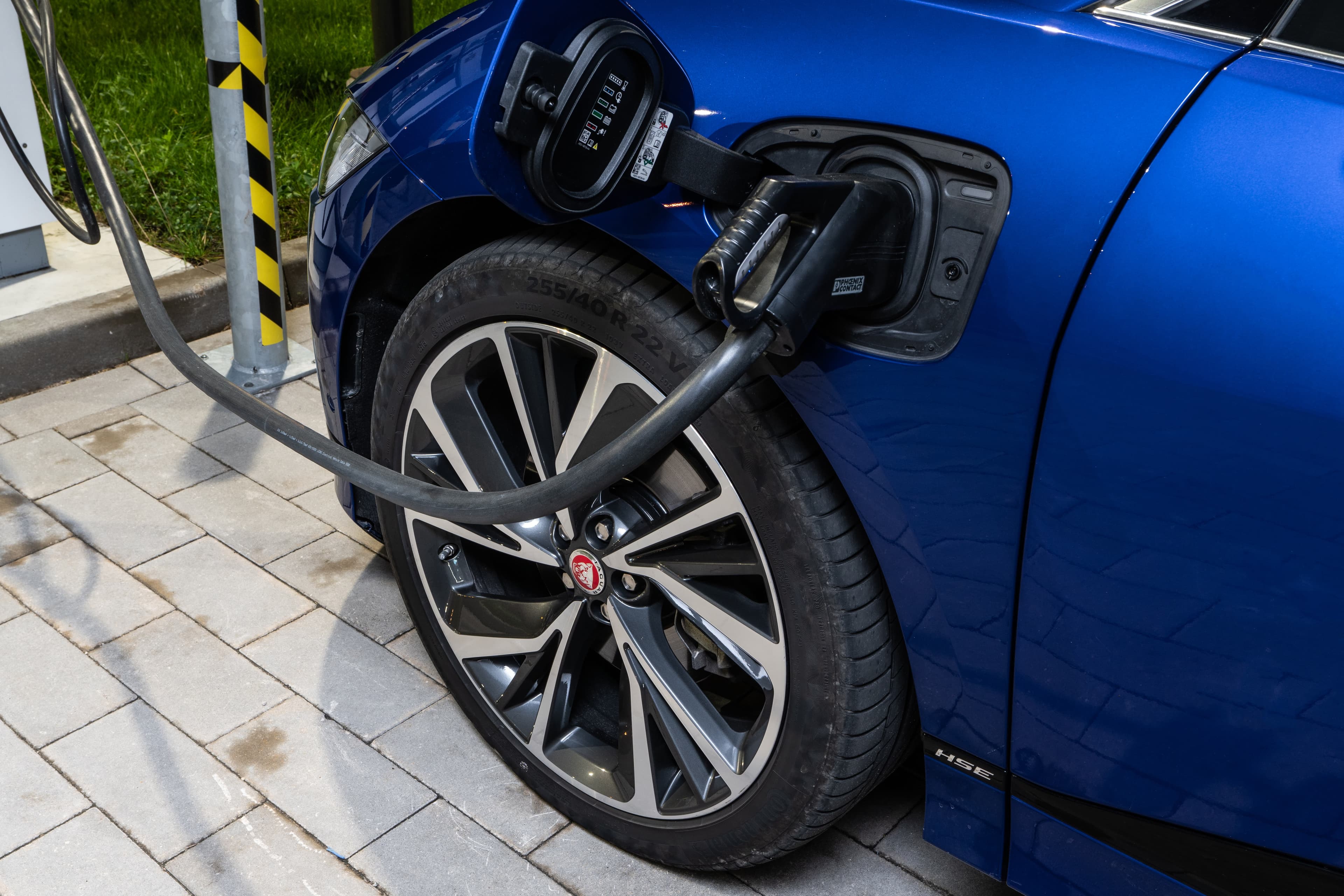 Blue Jaguar I-Pace Compact Luxury Electric CUV Plugged Into Electric Charger